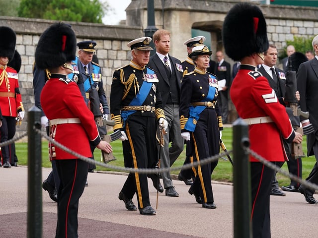 (left to right) The Prince of Wales,(hidden) the Duke of Sussex, Peter Phillips, King Charles III, the Princess Royal and the Duke of York follow the State Hearse carrying the coffin of Queen Elizabeth II, draped in the Royal Standard with the Imperial State Crown and the Sovereign's Orb and Sceptre, as it arrives at the Committal Service held at St George's Chapel in Windsor Castle, Berkshire. Picture date: Monday September 19, 2022.