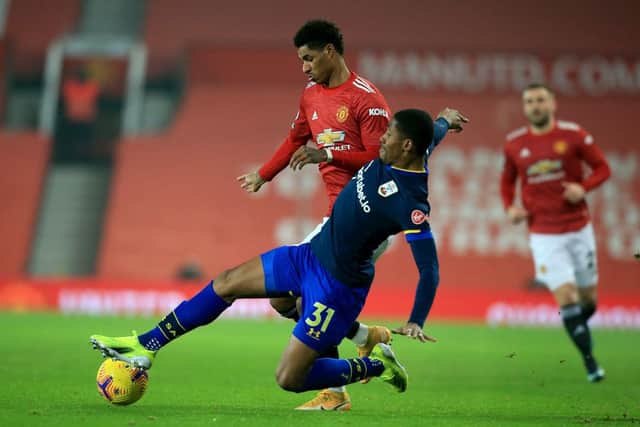 Marcus Rashford of Manchester United is challenged by Kayne Ramsay of Southampton. (Photo by Lindsey Parnaby - Pool/Getty Images)