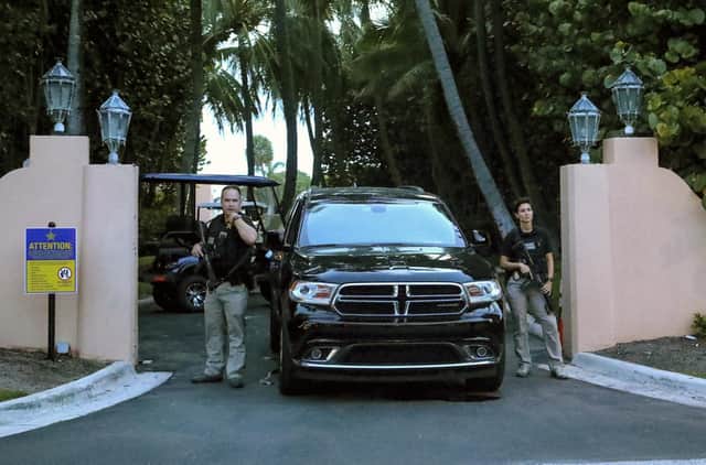 Secret Service agents stand at the gate of Mar-a-Lago after the FBI issued warrants at the Palm Beach, Fla., estate, Monday, Aug. 8, 2020. Former President Donald Trump said in a lengthy statement that the FBI was conducting a search of his Mar-a-Lago estate and asserted that agents had broken open a safe.