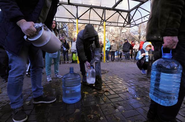 People queue to collect water from a pump in a park in Kyiv on October 31 after Russian missile strikes on energy facilities stopped domestic supplies (Picture: Sergei Chuzavkov/AFP via Getty Images)
