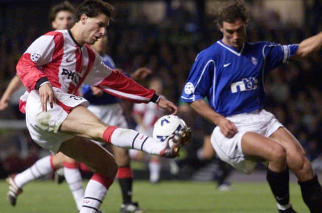 Ruud van Nistelrooy played against Rangers for PSV in the Champions League in 1999. Here he takes on Lorenzo Amoruso. PSV lost 4-1 at Ibrox