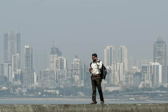 A man speaks on a mobile phone near the seafront overlooking the city skyline in Mumbai. Modelling from the Department for Business and Trade suggests projected trade with India could increase by 40-79 per cent by 2035 (Picture: Punit Paranjpe PUNIT/AFP via Getty Images)
