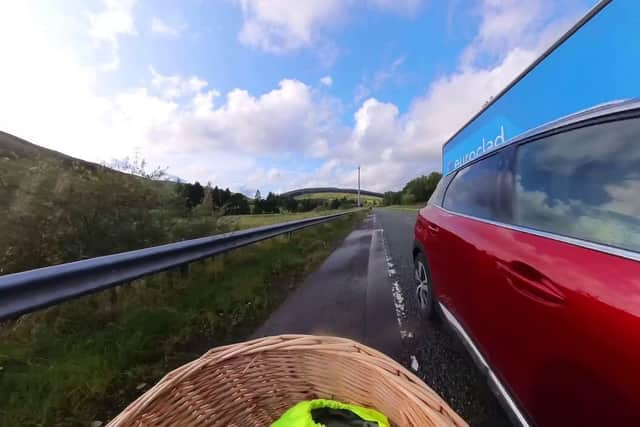 Lady Bathurst, 58, is narrowly missed by an overtaking car whilst cycling for charity. Picture: Tom Wakefield/Cotswold TV/SWNS