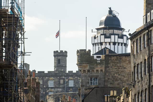 PIC LISA FERGUSON: Flags fly at half mast on Edinburgh Castle, and City Chambers