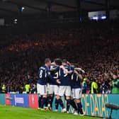 The Scotland players celebrate during the famous victory over Spain.