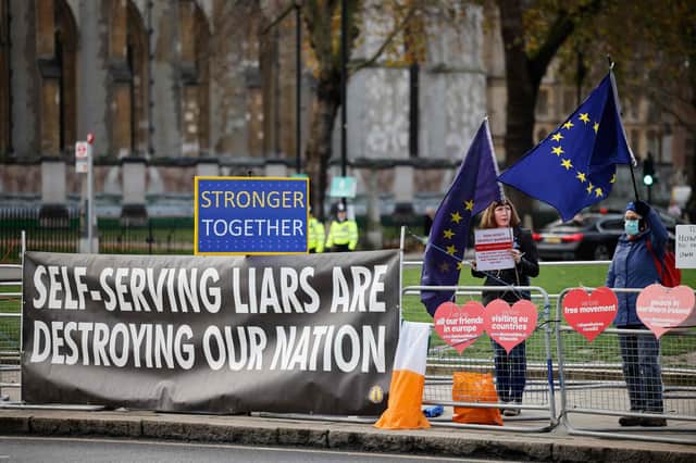 Pro-EU anti-Brexit protesters hold placards and EU flags outside the Houses of Parliament in London. Picture: Tolga Akmen/AFP via Getty Images
