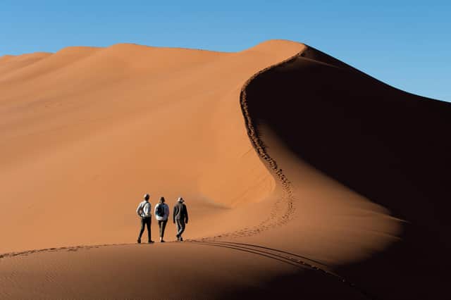 Tourists climbing Big Daddy dune in Namib-Naukluft – Namibia's biggest national park.