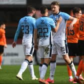 The Ross County players celebrate at full time after defeating Dundee United 2-0.