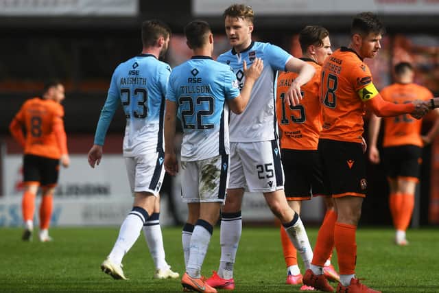 The Ross County players celebrate at full time after defeating Dundee United 2-0.