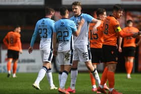 The Ross County players celebrate at full time after defeating Dundee United 2-0.