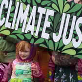 Climate Justice Activists at the Cop26 Gates asking delegates as they make final decisions, "Are You With Us Or With Fossil Fuels?"