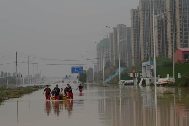 Rescue workers in Zhengzhou, China, move through floods that claimed the lives of at least 33 people last week (Photo by Noel Celis / AFP) (Photo by NOEL CELIS/AFP via Getty Images)