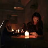 People sit in a café without power in Lviv, Ukraine. Once a safe haven for refugees, Russian attacks have plunged the city into darkness and cold (Picture: Jeff J Mitchell/Getty Images)