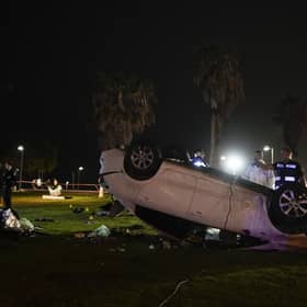 Israeli police stand around a car involved in an attack in Tel Aviv, Israel. (AP Photo/Ariel Schalit)