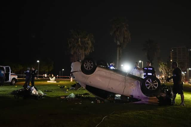 Israeli police stand around a car involved in an attack in Tel Aviv, Israel. (AP Photo/Ariel Schalit)