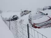 Vehicles sit along U.S. 131 north  by 84th Street on Friday, Dec. 23, 2022 in Byron Center, Mich.  A blizzard warning is in effect for Kent County and the surrounding region. Winter weather is blanketing the U.S. as a massive storm sent temperatures crashing and created whiteout conditions. (Neil Blake/The Grand Rapids Press via AP)