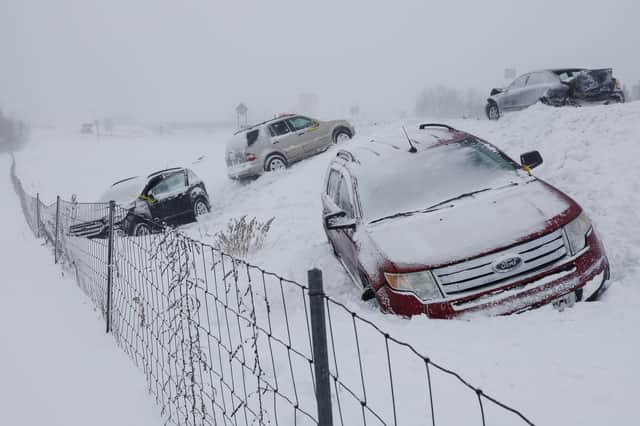 Vehicles sit along U.S. 131 north by 84th Street on Friday, Dec. 23, 2022 in Byron Center, Mich. A blizzard warning is in effect for Kent County and the surrounding region. Winter weather is blanketing the U.S. as a massive storm sent temperatures crashing and created whiteout conditions. (Neil Blake/The Grand Rapids Press via AP)