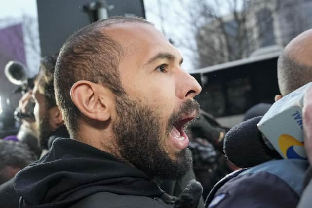 Police officers escort Andrew Tate, handcuffed to his brother Tristan, from the Directorate for Investigating Organized Crime and Terrorism. Picture: AP Photo/Andreea Alexandru