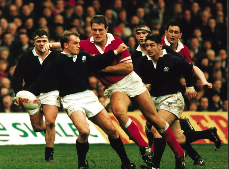 Gregor Townsend takes the brunt of the Welsh charge in the Scotland v Wales rugby game, 19 Feb 1996