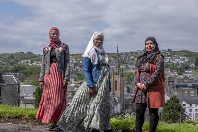 Wafa Murad with her friends, Sudanese sisters Sumaia Adam and Hanan Adam Mohamed, on a hill overlooking the town of Rothesay. Photo: Andrew Testa (UNHCR)
