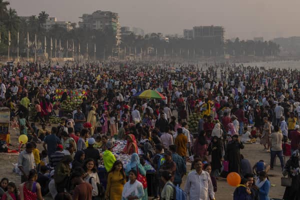 People crowd the Juhu beach on the Arabian Sea coast in Mumbai, India. The world's population is projected to hit an estimated 8 billion people on Tuesday, Nov. 15, according to a United Nations projection. (AP Photo/Rafiq Maqbool)