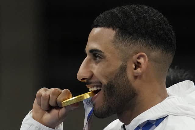 Britain's Galal Yafai bites his gold medal during the medal ceremony for the men's flyweight boxing competition at the 2020 Olympics. Picture: Themba Hadebe/AP