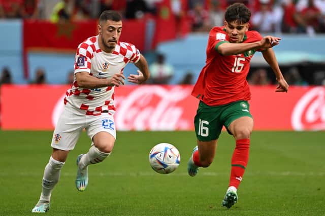 Croatia defender Josip Juranovic, of Celtic, is tracked by Morocco's Abde Ezzalzouli during the World Cup Group F clash at the Al-Bayt Stadium, Qatar. (Photo by OZAN KOSE/AFP via Getty Images)