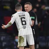 Hibs' Paul McGinn confronts referee John Beaton during the Premier Sports Cup final against Celtic.