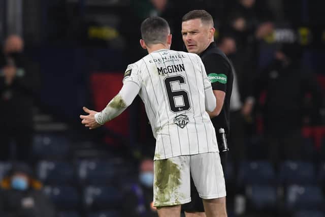 Hibs' Paul McGinn confronts referee John Beaton during the Premier Sports Cup final against Celtic.
