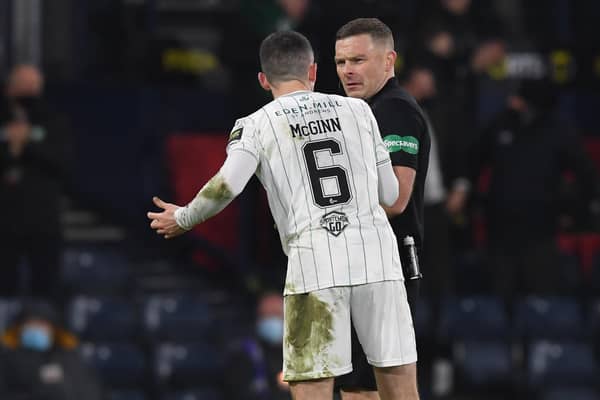 Hibs' Paul McGinn confronts referee John Beaton during the Premier Sports Cup final against Celtic.