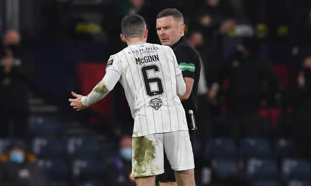Hibs' Paul McGinn confronts referee John Beaton during the Premier Sports Cup final against Celtic.