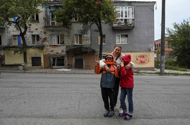 A woman with her two children in Izyum, Kharkiv region, recently liberated by Ukrainian forces (Picture: Juan Barreto/AFP via Getty Images)