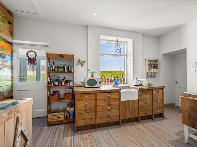 Interior: The accommodation in the one-time school is classy and features a light and airy lounge, a uniquely designed open-plan kitchen and dining space, a large principal bedroom with ensuite, and three good sized bedrooms. The home’s interior has been decorated to a high standard and the entrance features exquisite stained glass windows.
