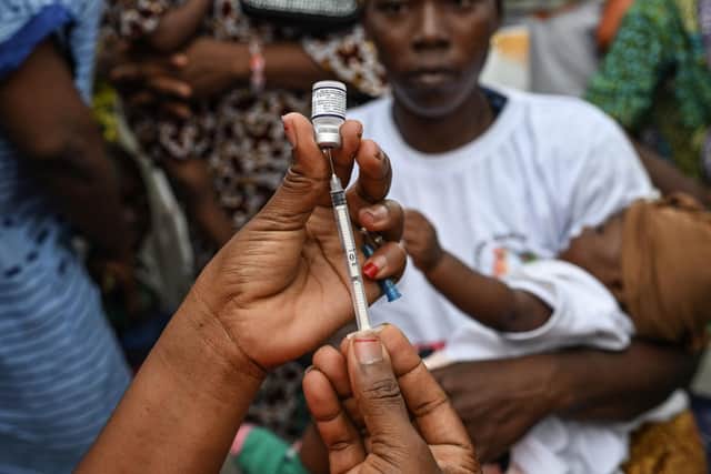 A health worker prepares a dose of a vaccine against malaria for an infant in Ivory Coast (Picture: Sia Kambou//AFP via Getty Images)