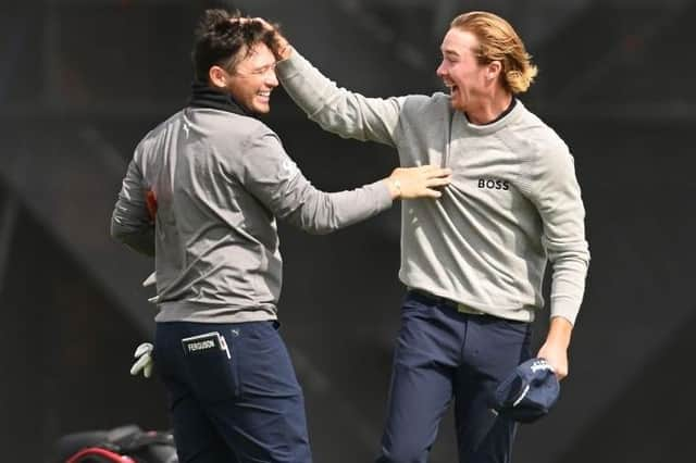 Ewen Ferguson gets a pat on the head from Sean Crocker after beating his course record from the previous day with an 11-under 61 in the second round of the Hero Open at Fairmont St Andrews. Picture: Ross Kinnaird/Getty Images.