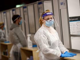 Health workers prepare to assist at a NHS Test and Trace Covid-19 testing unit at the Civic Centre in Uxbridge, Hillingdon, West London in 2021. Photo by ADRIAN DENNIS/AFP via Getty Images