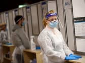 Health workers prepare to assist at a NHS Test and Trace Covid-19 testing unit at the Civic Centre in Uxbridge, Hillingdon, West London in 2021. Photo by ADRIAN DENNIS/AFP via Getty Images