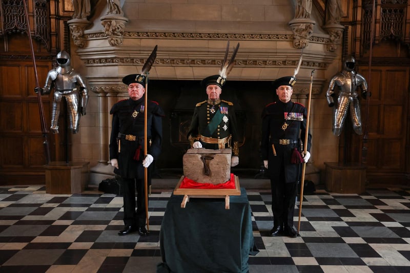 The Duke of Buccleuch (centre) flanked by two Officers of Arms stand beside the Stone of Destiny, which is also known as the Stone of Scone, in Edinburgh Castle before its onward transportation to be placed beneath the Coronation Chair at Westminster Abbey for the coronation of King Charles III.