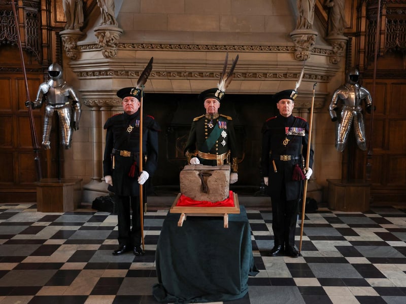 The Duke of Buccleuch (centre) flanked by two Officers of Arms stand beside the Stone of Destiny, which is also known as the Stone of Scone, in Edinburgh Castle before its onward transportation to be placed beneath the Coronation Chair at Westminster Abbey for the coronation of King Charles III.