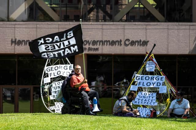 People gather before the sentencing hearing of former Minneapolis Police officer Derek Chauvin outside the Hennepin County Government Center on June 25, 2021 in Minneapolis, Minnesota(Photo by Kerem Yucel / AFP).