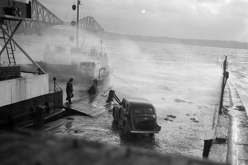 Stormy weather at North Queensferry as a car boards the ferry for the crossing of the Forth to South Queensferry in January 1953
