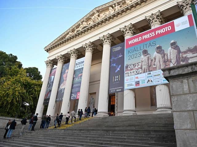 People wait in the queue to visit the exhibition of the World Press Photo at the Hungarian National Museum in Budapest.