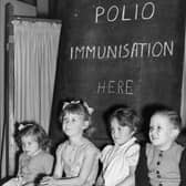 Children wait to be vaccinated against polio in 1956  (Photo by Terry Fincher/Getty Images)