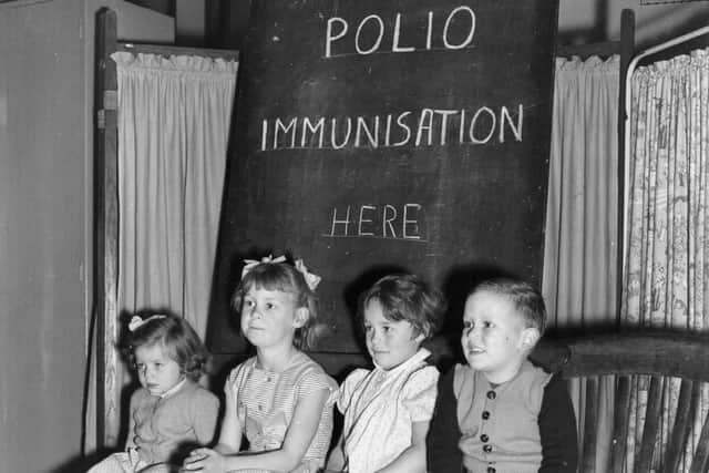 Children wait to be vaccinated against polio in 1956 (Photo by Terry Fincher/Getty Images)
