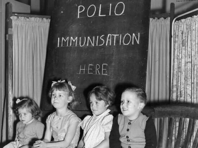 Children wait to be vaccinated against polio in 1956  (Photo by Terry Fincher/Getty Images)