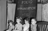 Children wait to be vaccinated against polio in 1956  (Photo by Terry Fincher/Getty Images)