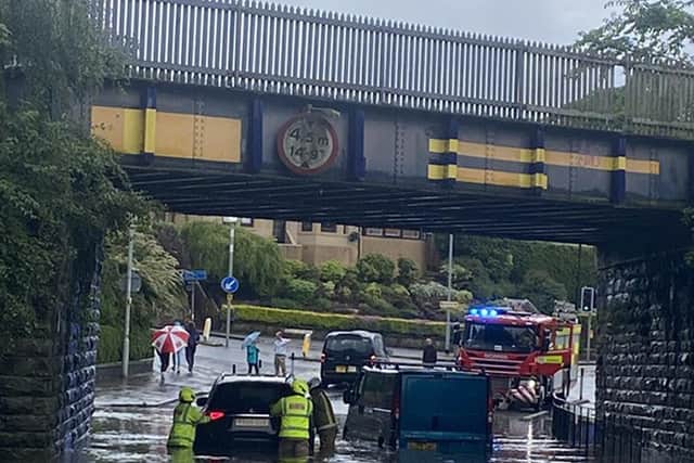 @nicolaawilson snapped emergency services helping vehicles which were stuck in flood water under a bridge in Chesser, Edinburgh, during Sunday's stormy weather. (Image credit: @nicolaawilson/PA Wire)