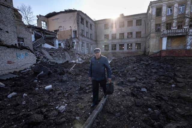 A man walks near a damaged school, next to a police building in Kramatorsk, Donbas Region of eastern Ukraine