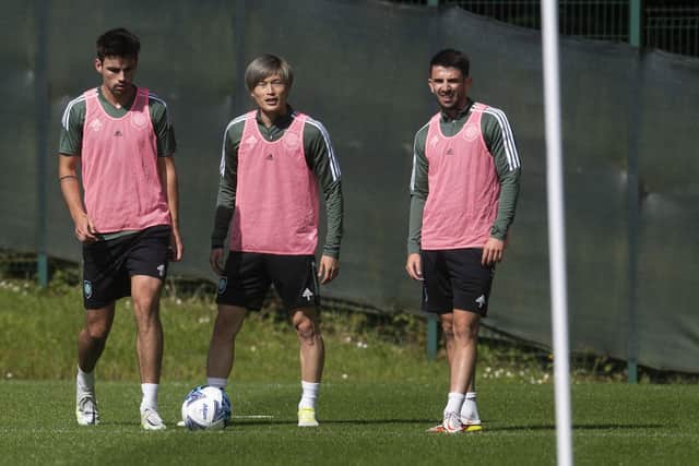 Celtic trio Matt O'Riley, Kyogo Furuhashi and Greg Taylor (L-R) during a training session at Lennoxtown ahead of a flight out to Austria.