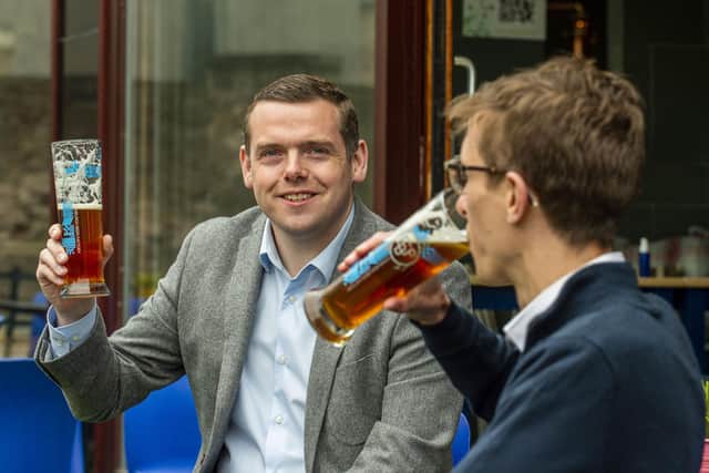 Scottish Conservative Leader Douglas Ross enjoys a pint as pubs begin to reopen.